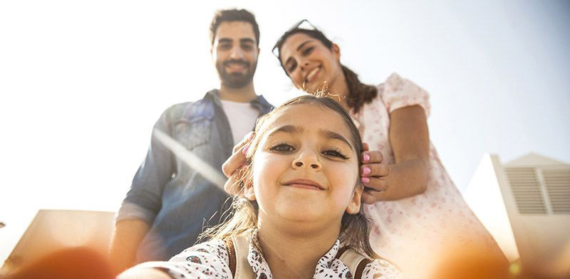 girl taking selfie with parents