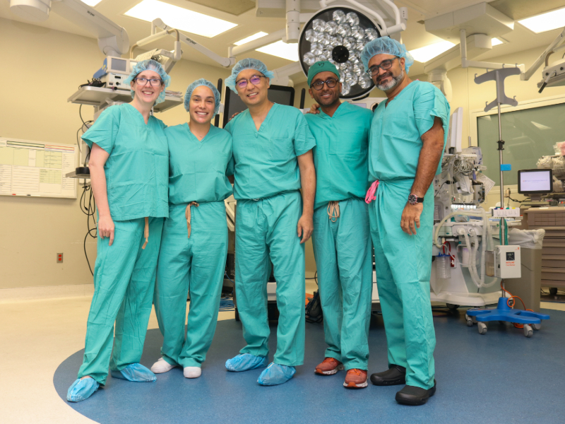 This image shows a group of surgeons standing in an operating room.