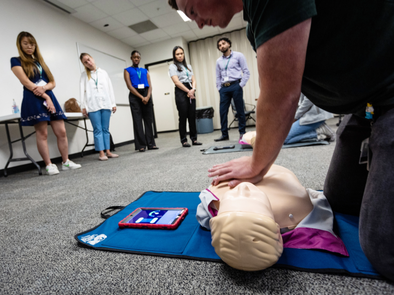This image shows a person doing a CPR demonstration 