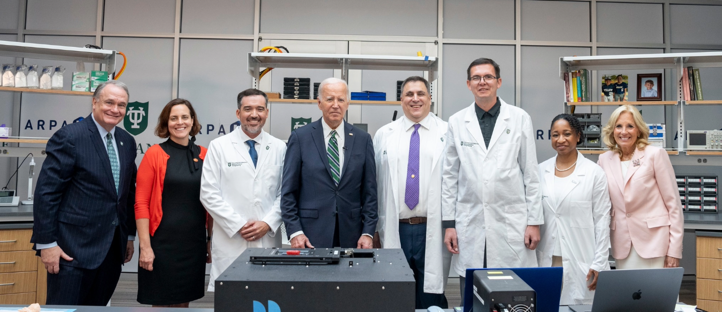 This photo shows a group of people standing in a lab