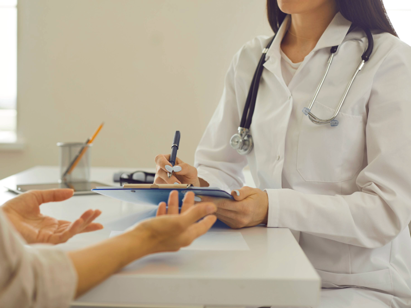 A woman's hands as she's speaking to a physician