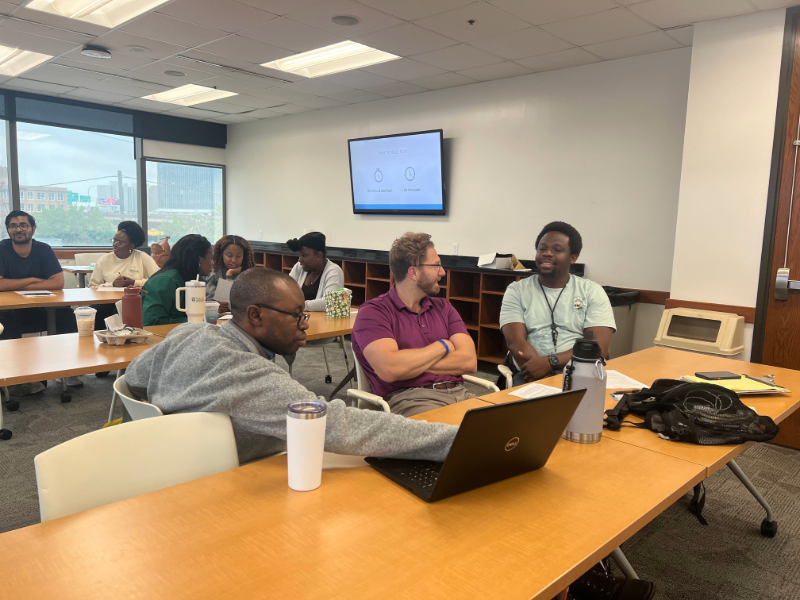 A group of resident physicians talking in a classroom