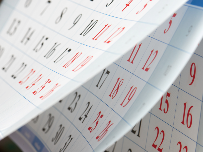 A close up photo of a calendar with the pages fluttering