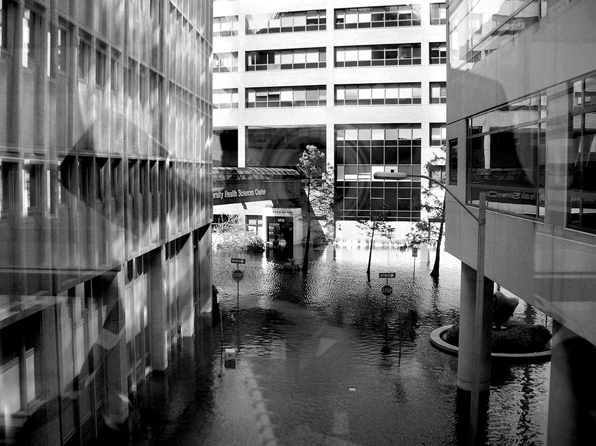 A black and white photo of flooding of Tulane Hospital on the street