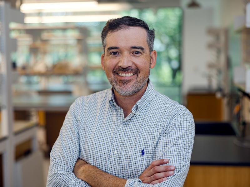 J. Quincy Brown stands with arms cross and smiling