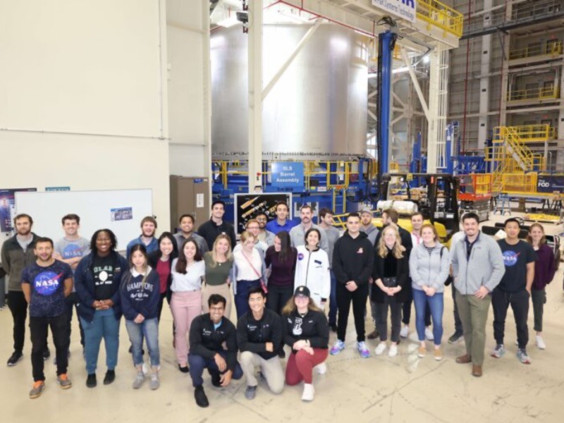 This image shows a group of people in a NASA facility