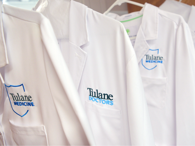 This image shows white lab coats hanging up.