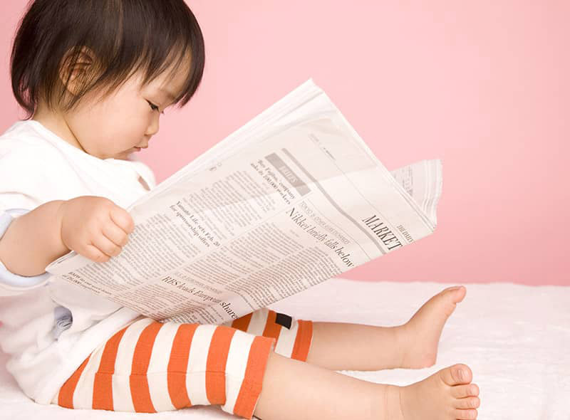 baby reading the newspaper