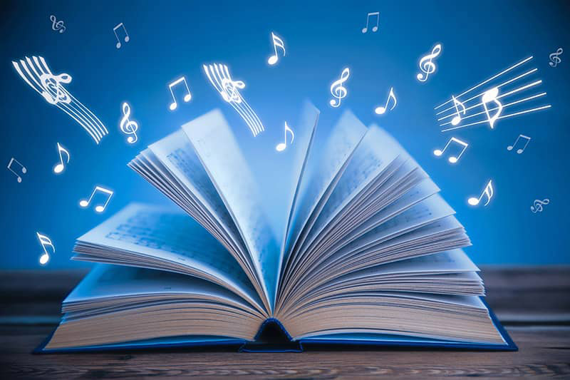 book with musical notes flying out