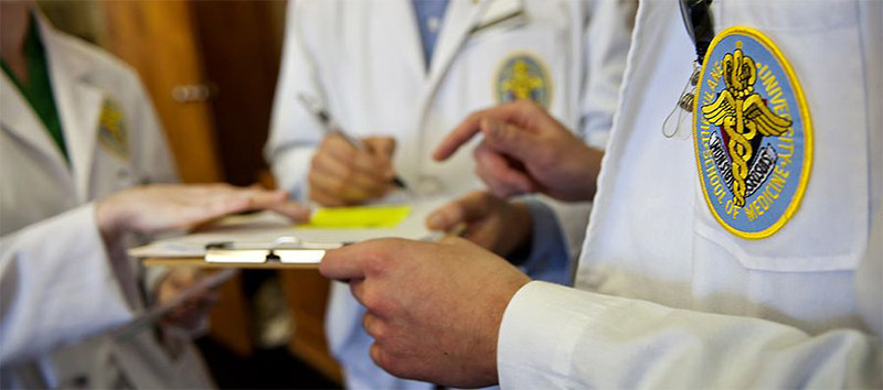 doctors hands viewing clipboard