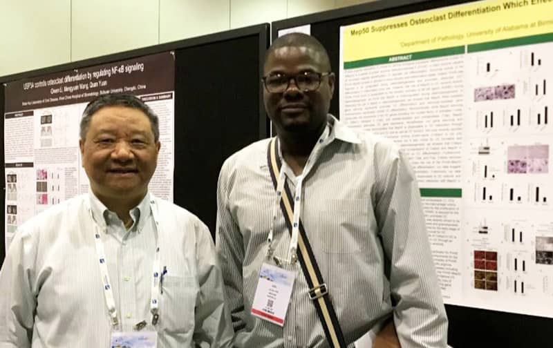 Dr. Li and another male at a poster conference
