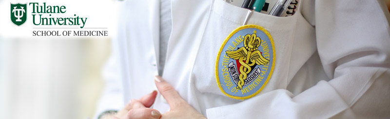 doctor's white coat; hands folded in front