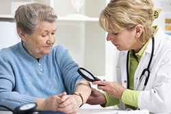 older woman with dermatologist