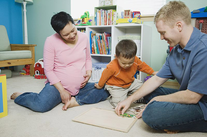 parents playing with child & puzzle