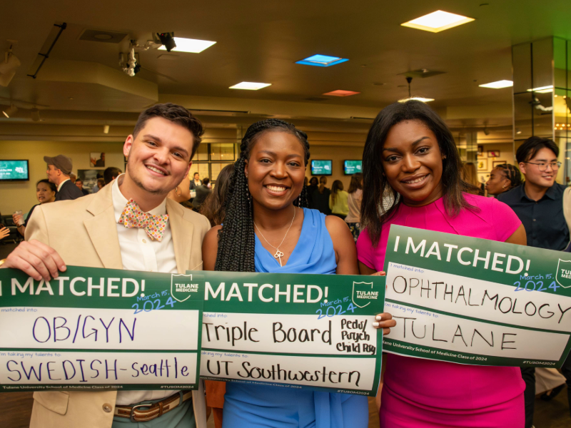 This image shows three medical students holding their Match Day signs