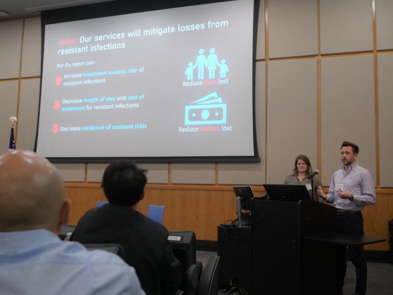This image shows people presenting research at a conference