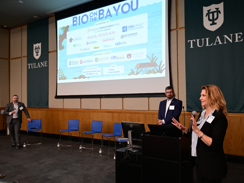 This is a photo of three people giving a presentation