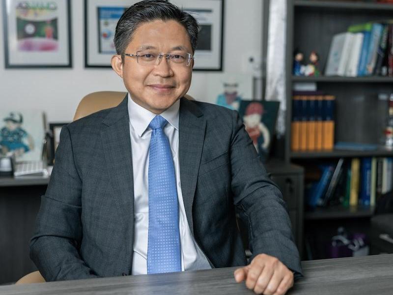 Tony Hu sitting at a desk
