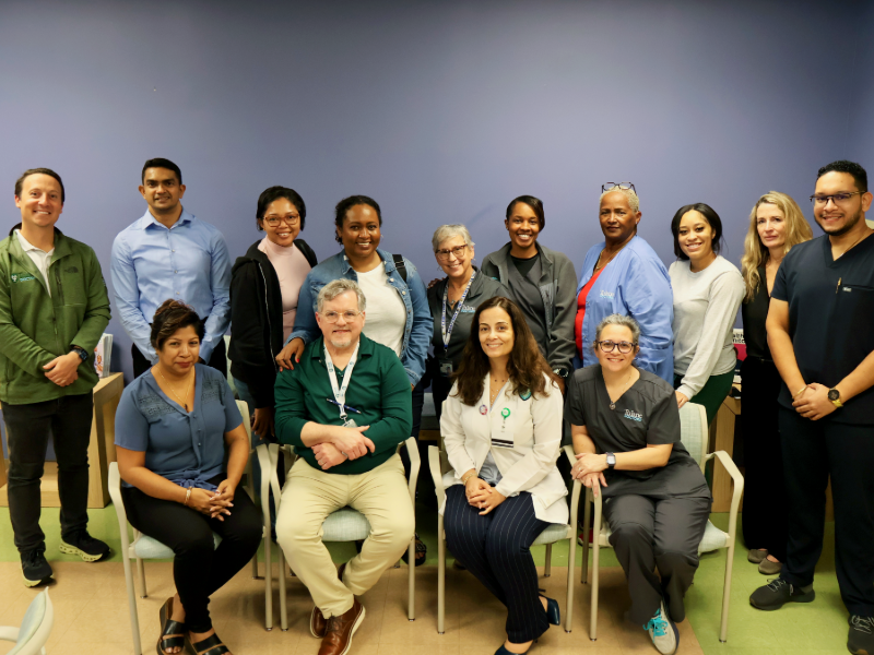 Fourteen healthcare workers pose for a group photo.