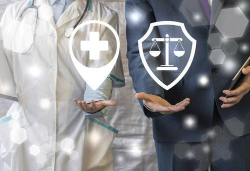 Male and female doctors hands with symbols of a hospital & scales overlaying them