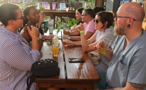 folks sitting around pints of beers