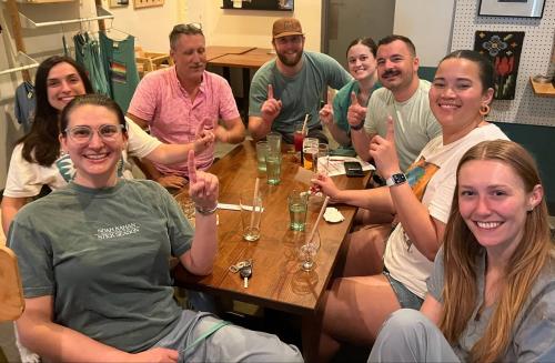Trivia team winners a group around a table in scrubs