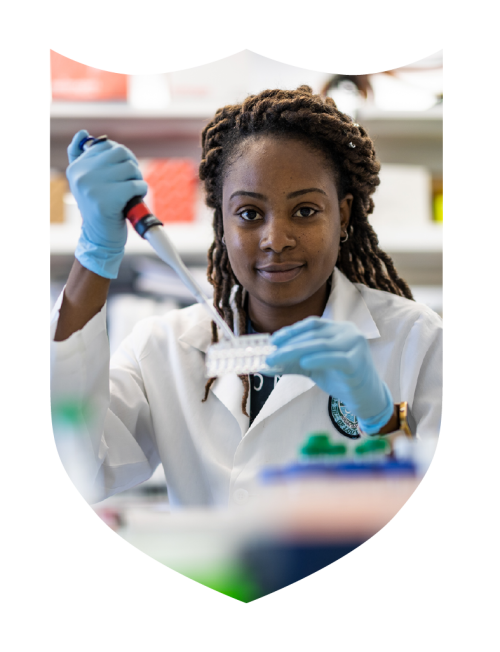 Researchers with a syringe in a Tulane shield