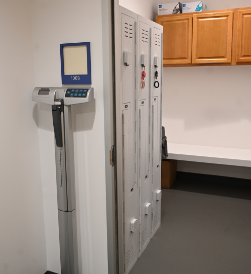 a changing room with lockers and a weight scale