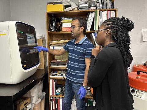 Lab members explaining QuantStudio for QPCR