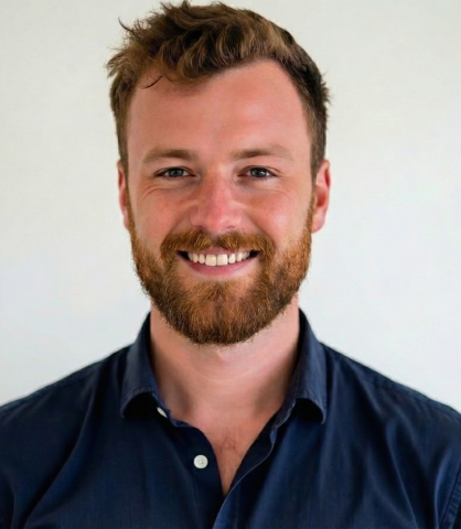 Photograph: Smiling man with a beard. 