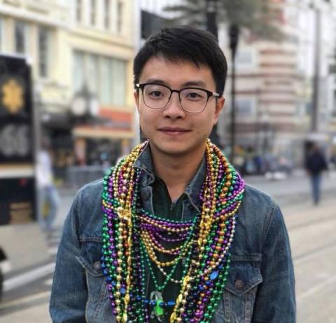 Troy Zhang after mardi gras parade, lots of beads