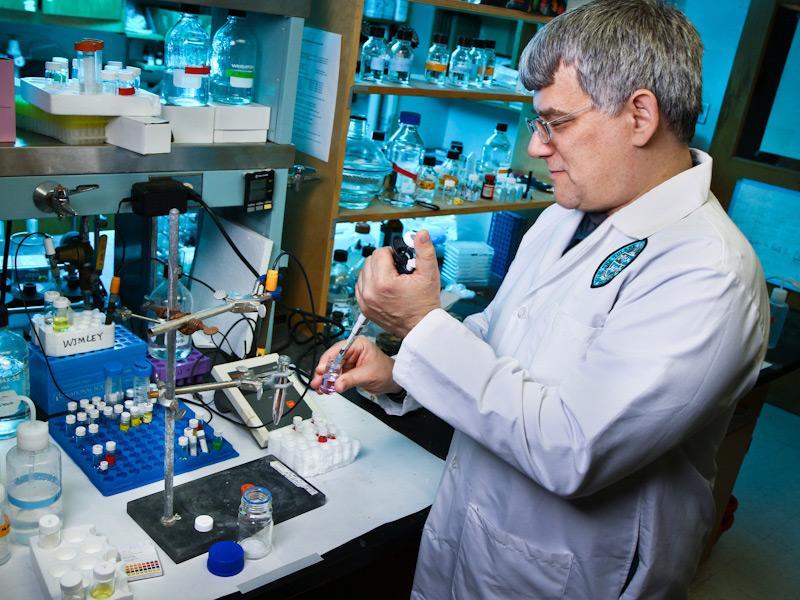 This is a photo of Bill Wimley working in a lab.