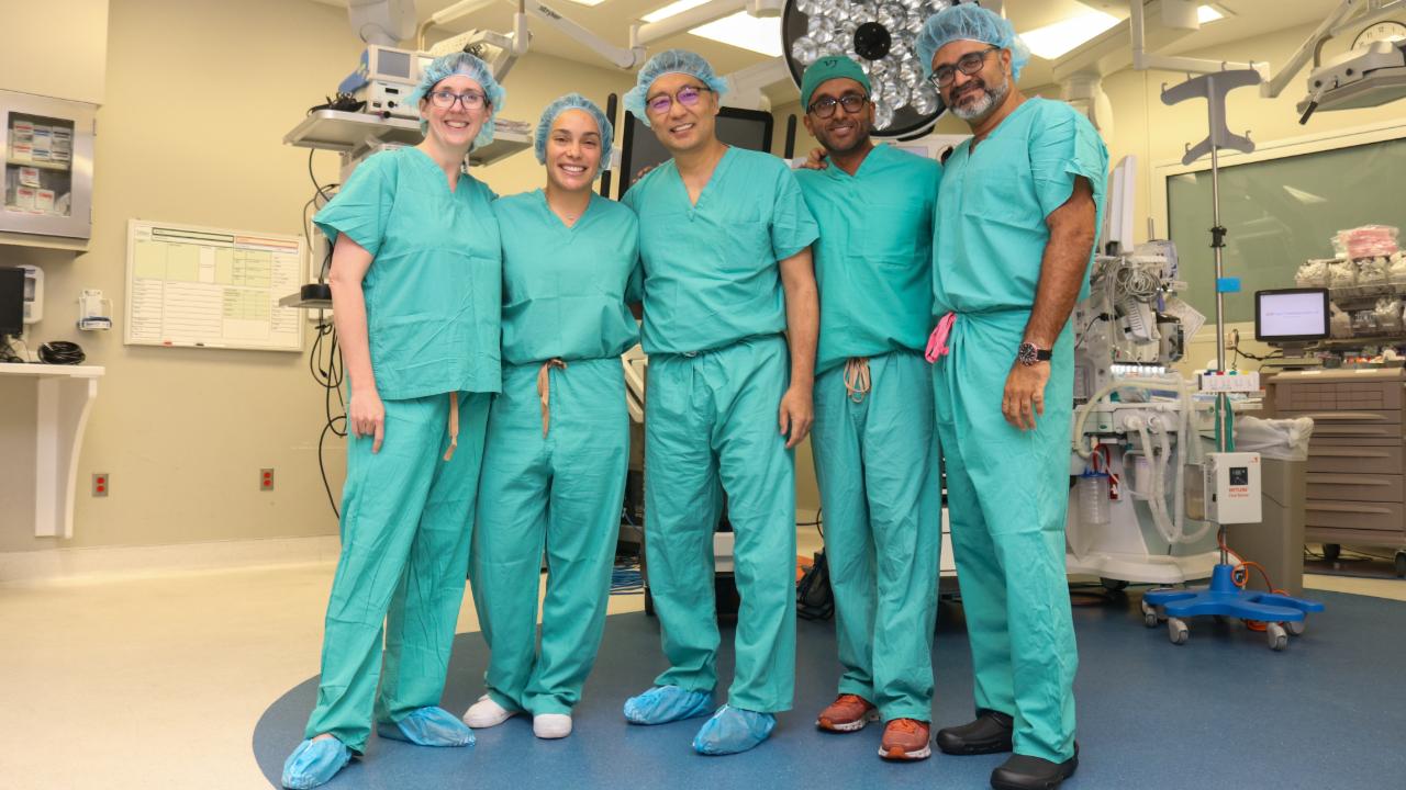 This image shows a group of surgeons standing in an operating room.