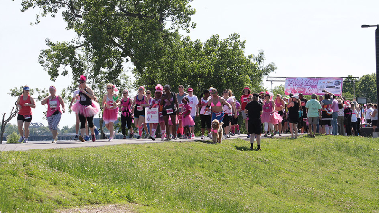 This image shows a group of people wearing pink participating in a 5K