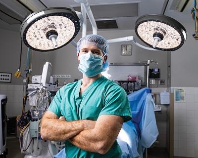 Surgeon posing in scrubs in operating room