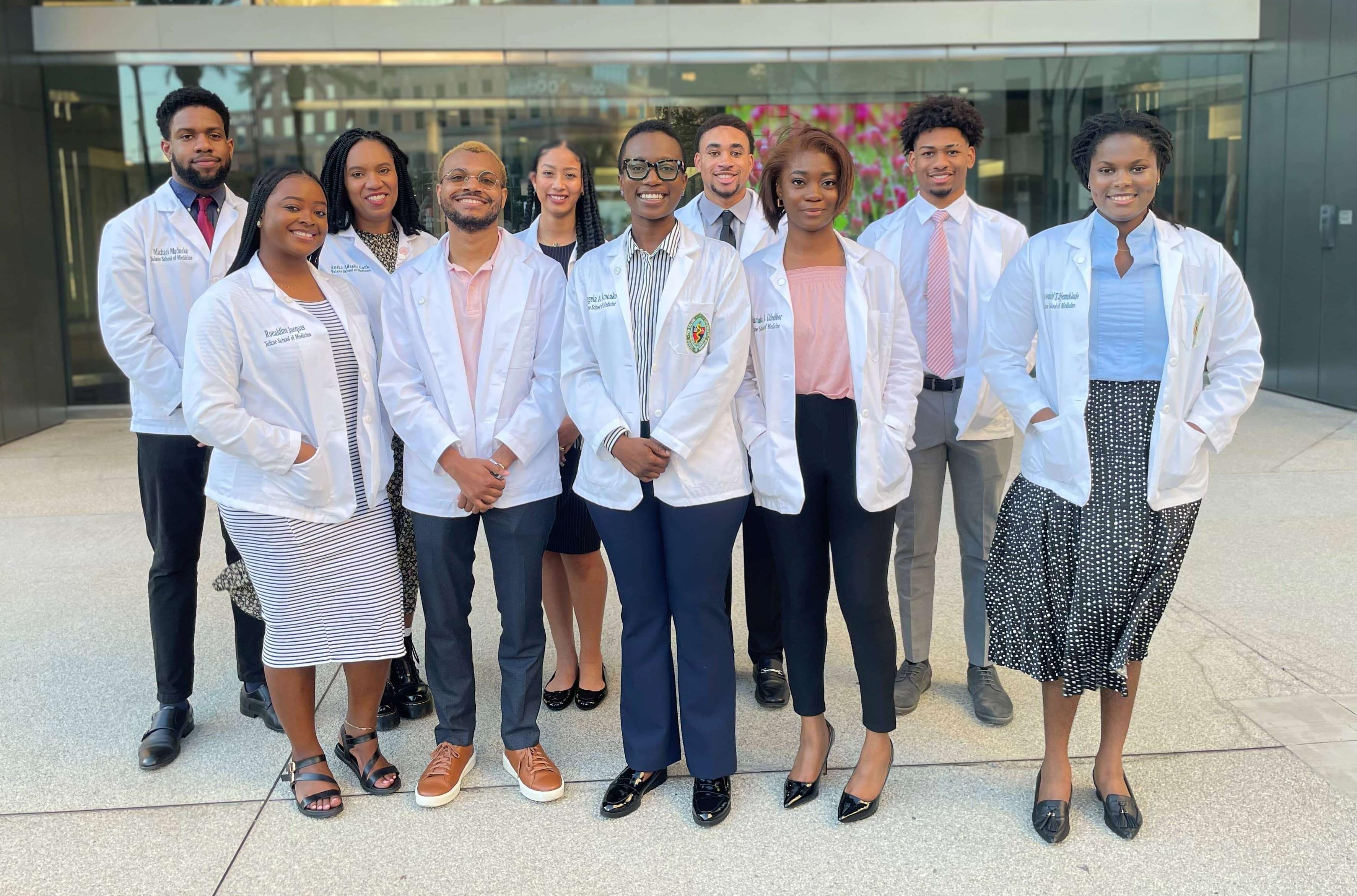 SNMA eboard leadership in their white coats