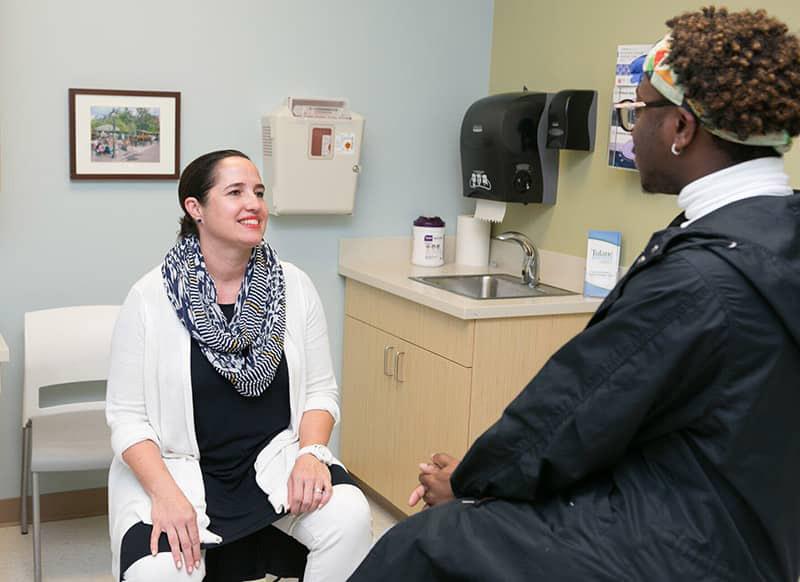 Dr. Julie Finger meets with a patient in the clinic