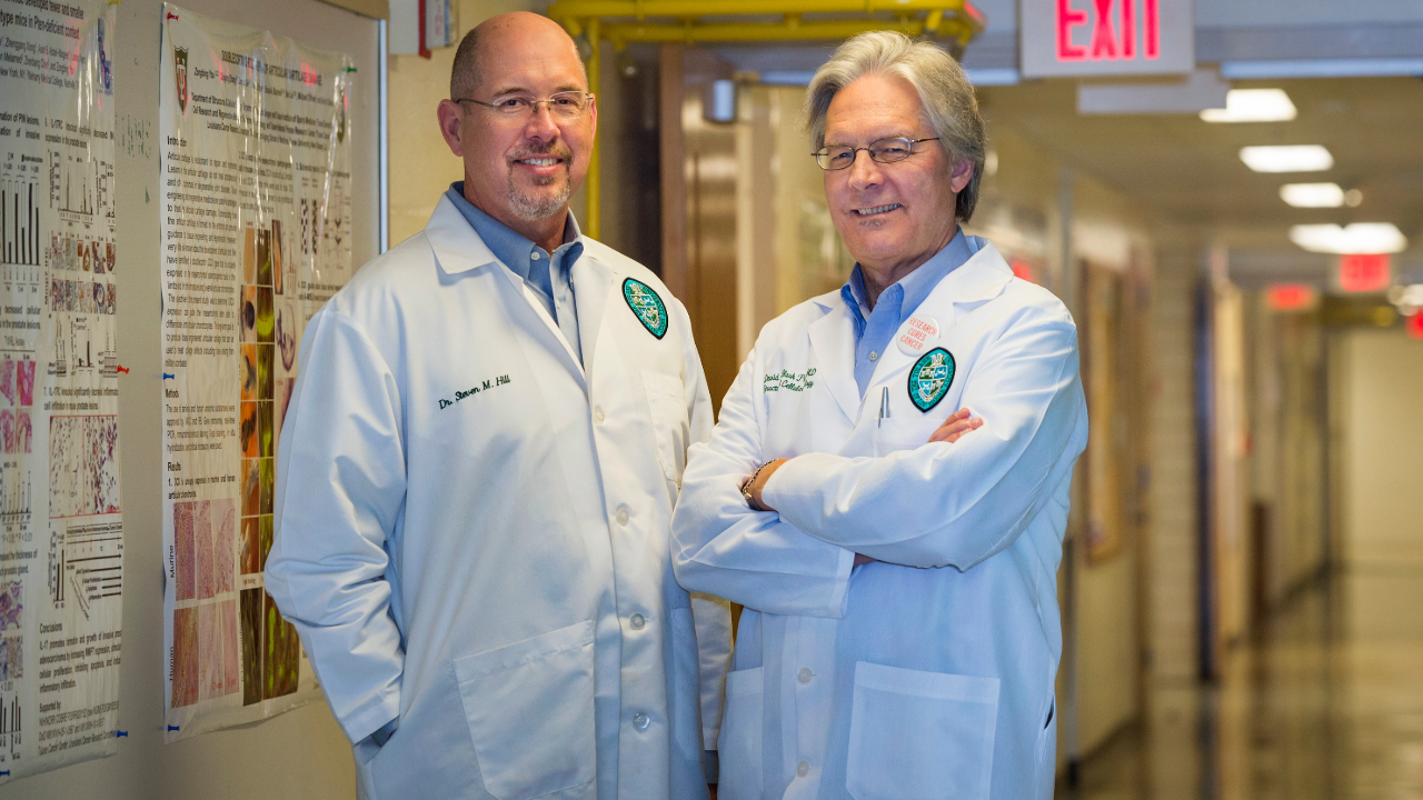 This image shows two men in white lab coats