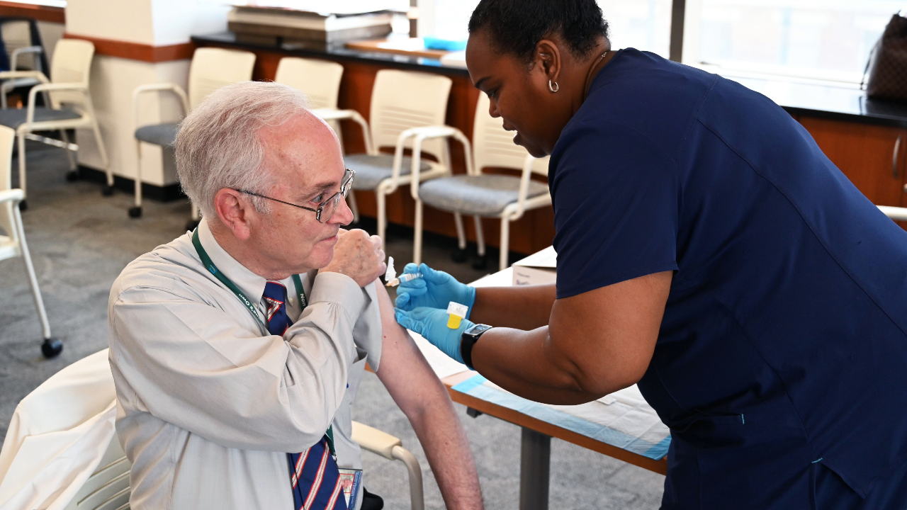 This is a photo of a nurse administering a shot to a person