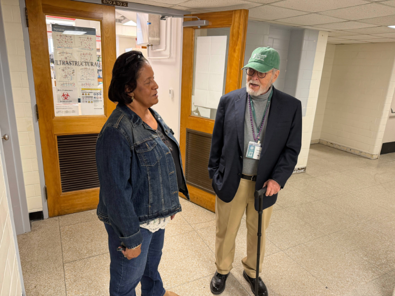 A woman and man stand in a hallway