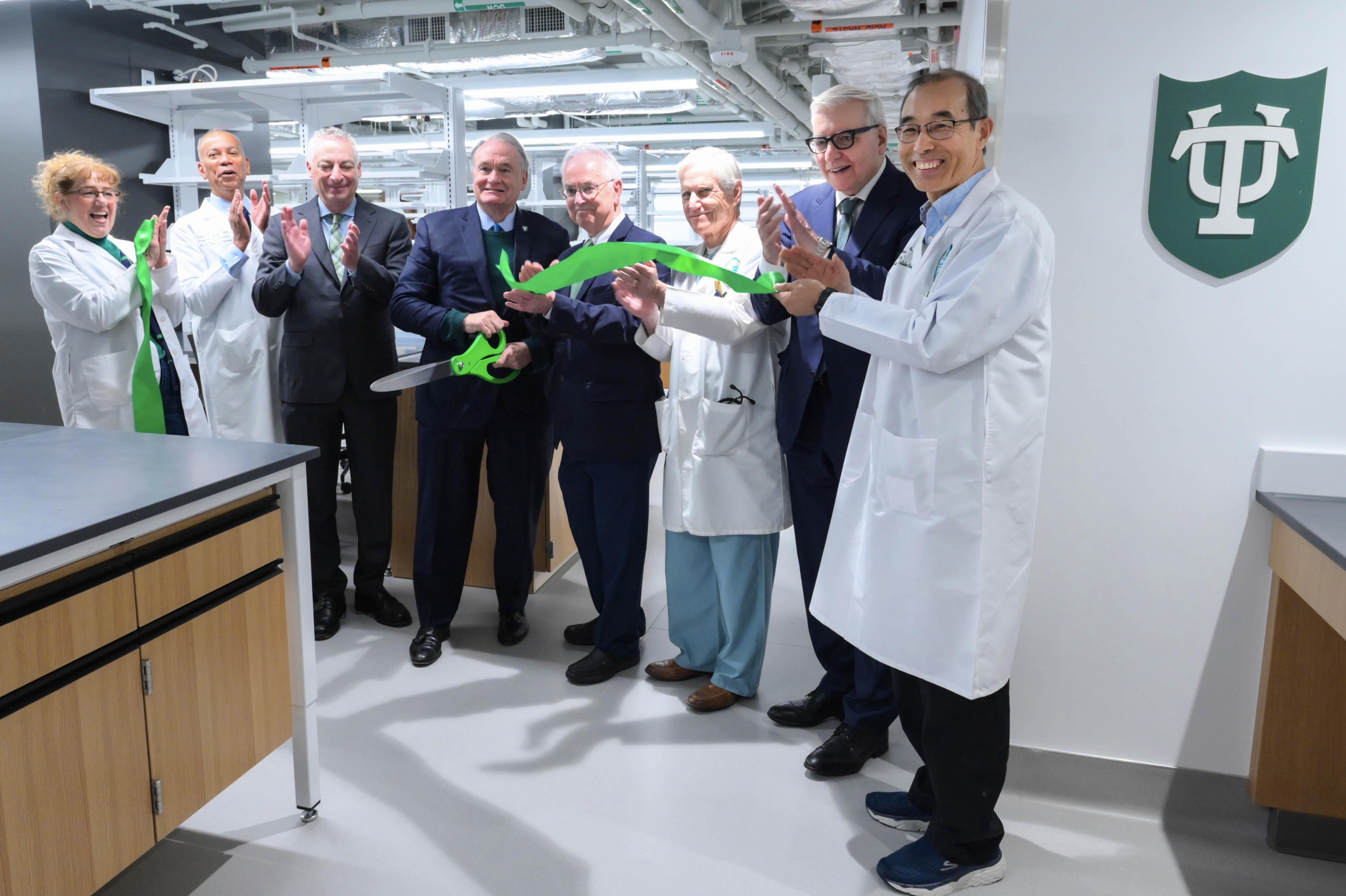 Tulane president Mike Fitts joins other Tulane leaders for the ribbon cutting to open two newly renovated spaces