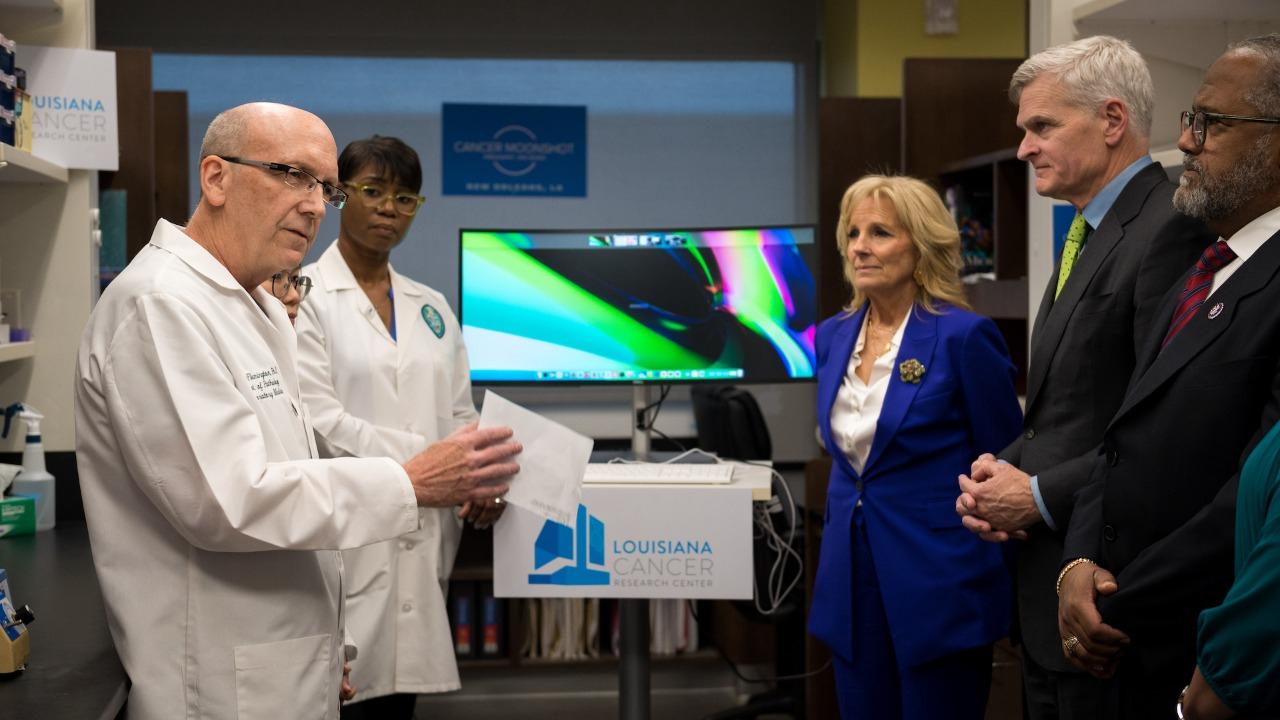 This image shows First Lady Jill Biden and Senator Bill Cassidy talking with Tulane researchers