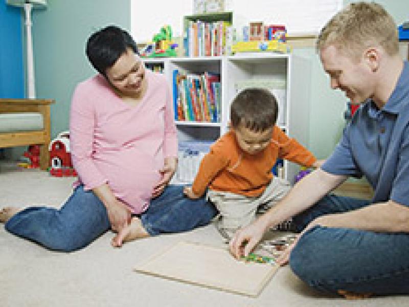 parents playing on the floor with child