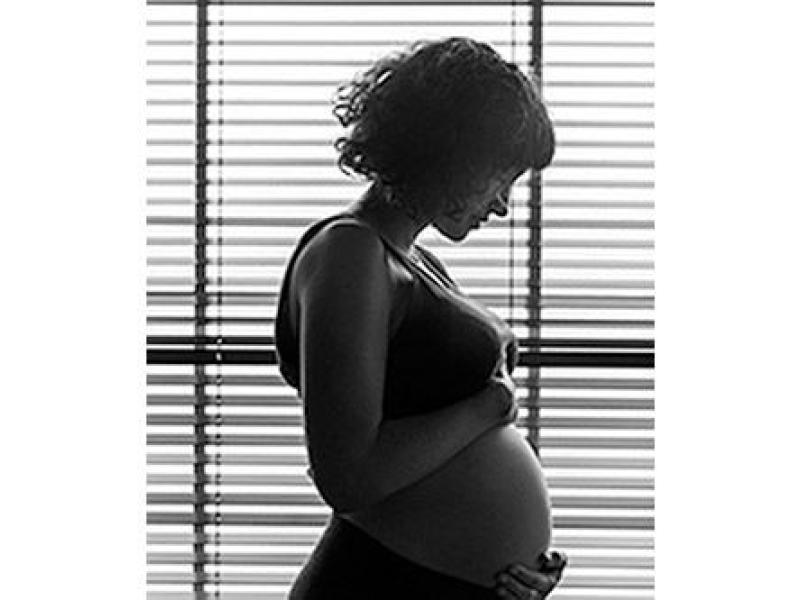 pregnant woman next to window