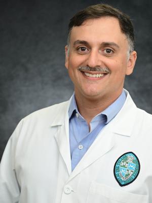 Photo depicts Jacob Bitoun, a smiling caucasian man wearing a white lab coat