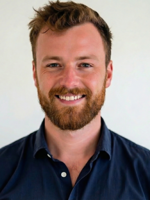 Photograph: Smiling man with a beard. 
